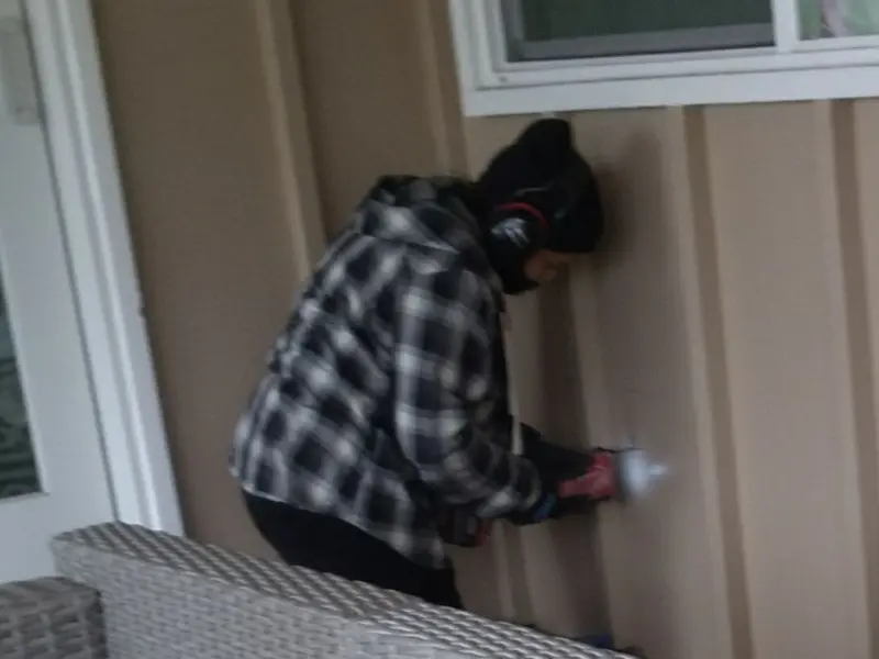 Professional electrician installing an exterior outlet in Ada
